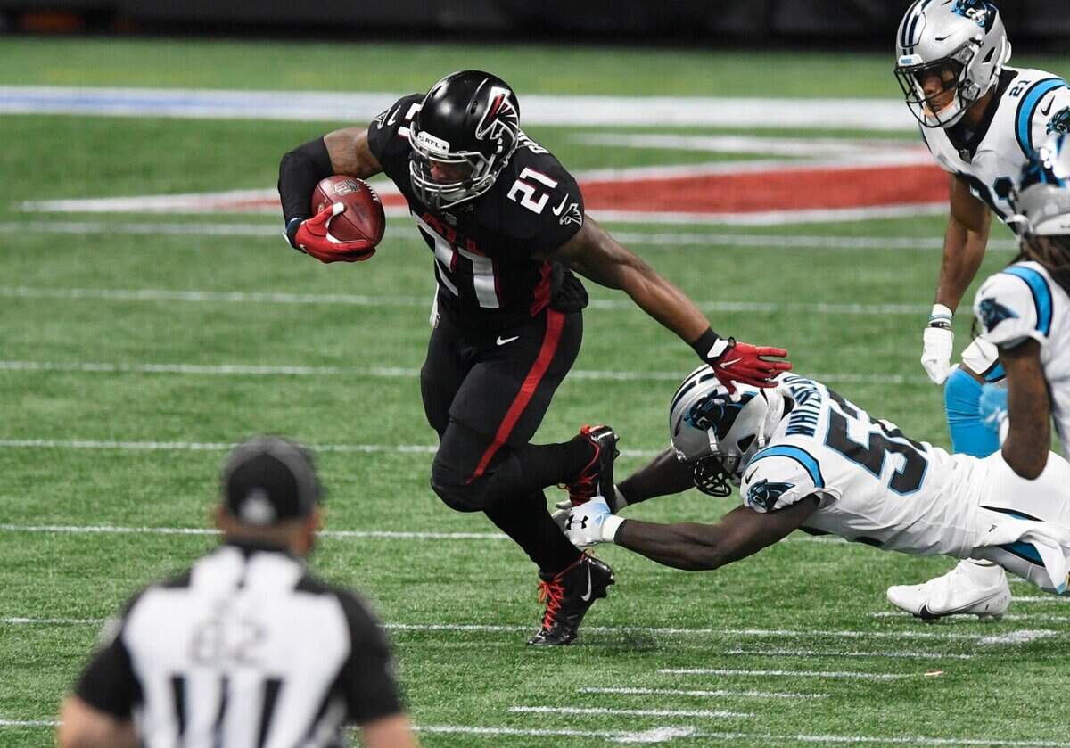 Carolina Panthers middle linebacker Tahir Whitehead (52) works to slow down Atlanta Falcons running back Todd Gurley (21) in the second half at Mercedes-Benz Stadium in Atlanta, GA on Sunday, October 11, 2020. The Panthers won 23-16.