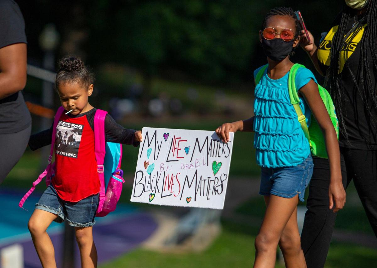 Israel Peyton-Rogers, 4, left, and Journee Baron-Carroll, 9, march with their mothers around Latta Park for the Black Mamas march in Charlotte, NC on Sunday, June 14, 2020. Organizers wanted a space for mothers to be heard and safely march as demonstrators across the country protest the death of George Floyd.