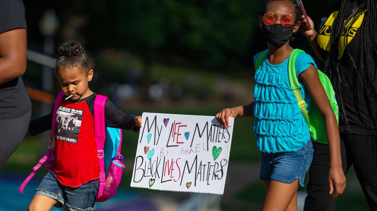 During the pandemic Black and Brown Americans faced the additional stress of dealing with a rise in racism. In this June 14, 2020 file photo, Israel Peyton-Rogers, 4, left, and Journee Baron-Carroll, 9, participated with their mothers in a Black Mamas march in Charlotte. Organizers wanted a space for mothers to be heard and safely march as demonstrators across the country protested the death of George Floyd.