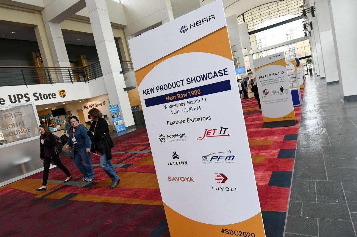 Convention attendees of the NBAA 2020 Schedulers & Dispatchers Conference (SDC2020) walk near the registration desk at the Charlotte Convention Center on Tuesday, March 10, 2020. Conventions across the nation are being cancelled or rescheduled in wake of spreading novel coronavirus.