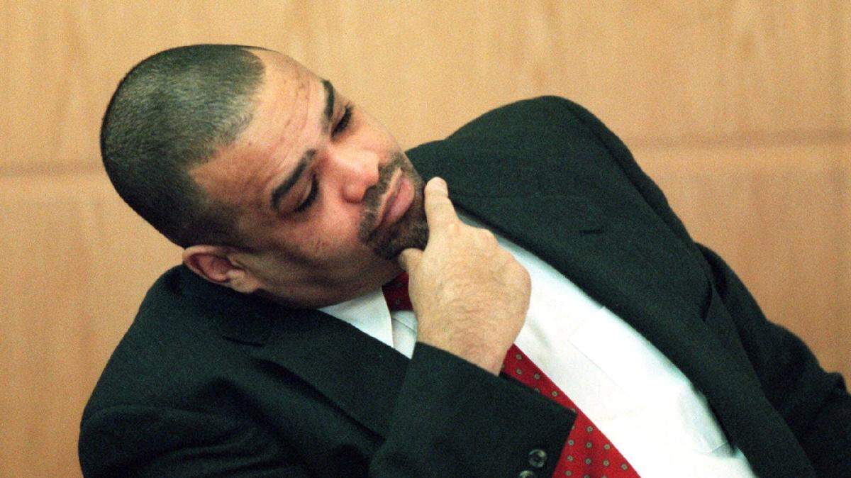 Van Brett Watkins considers a question asked by defense attorney David Rudolf on Dec. 20, 2000, in Charlotte, during the capital murder trial of Rae Carruth. Watkins was convicted for shooting Cherica Adams and spent the rest of his life in prison following the trial. He died on Dec. 3, 2023, at age 63.