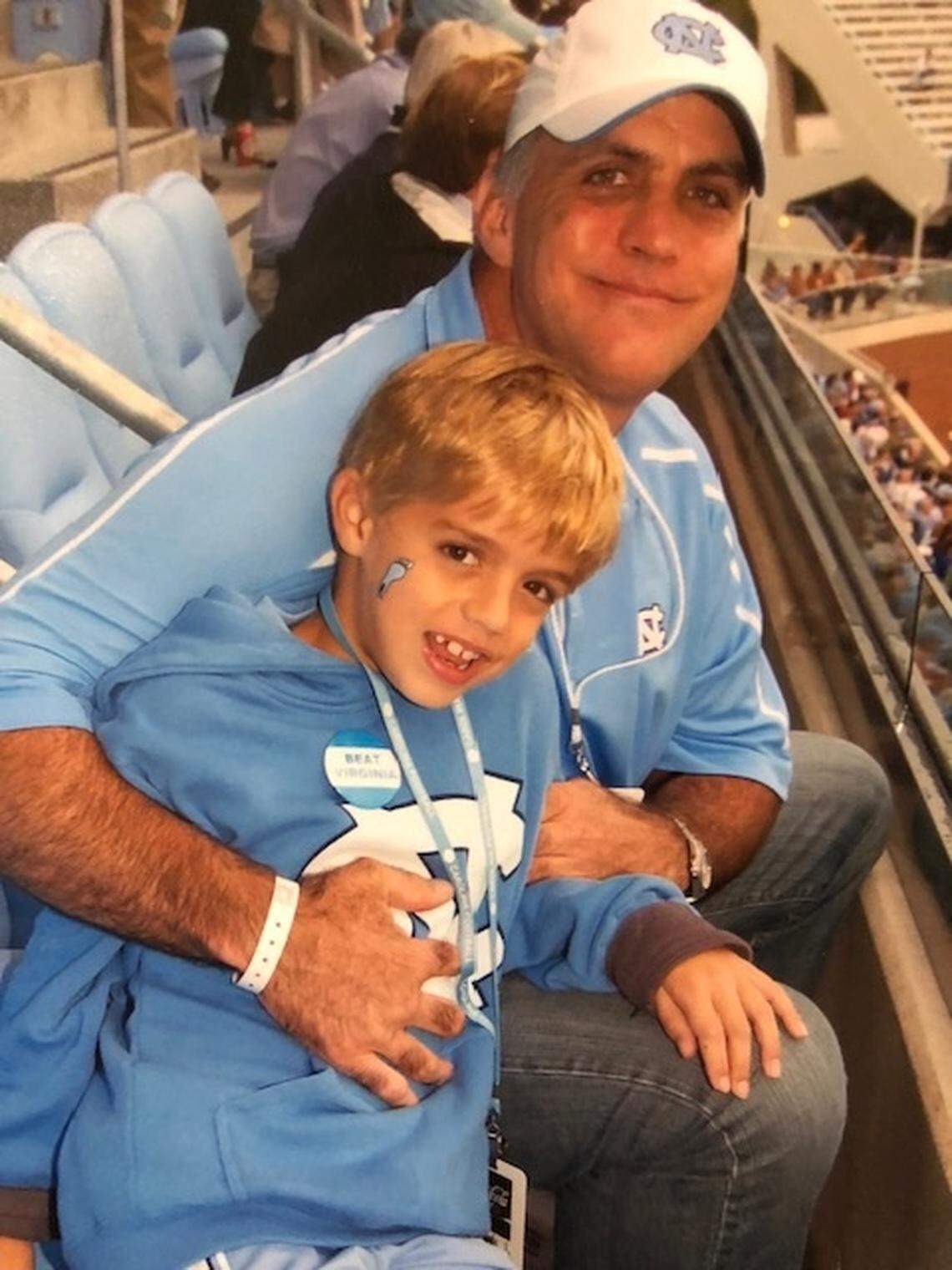 Deems May with his dad, Deems Jr, at a UNC game when he was younger