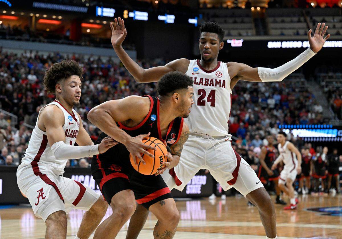 San Diego State Aztecs guard Matt Bradley (20) is trapped by Alabama Crimson Tide guard Mark Sears (1) and forward Brandon Miller (24) during the second half of the NCAA tournament round of sixteen at KFC YUM! Center.