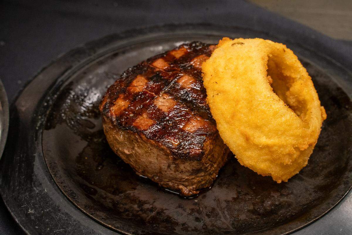 Steaks come with an onion ring at Beef ‘N Bottle.