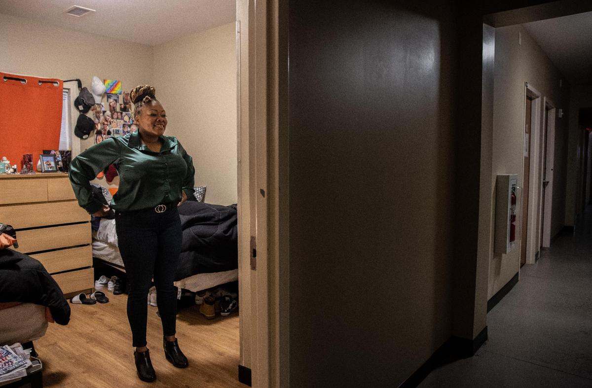 Shaheedah Martin, at the Center for Community Transitions in Charlotte, looks in the mirror before her first day of work on Friday, July 2, 2021.