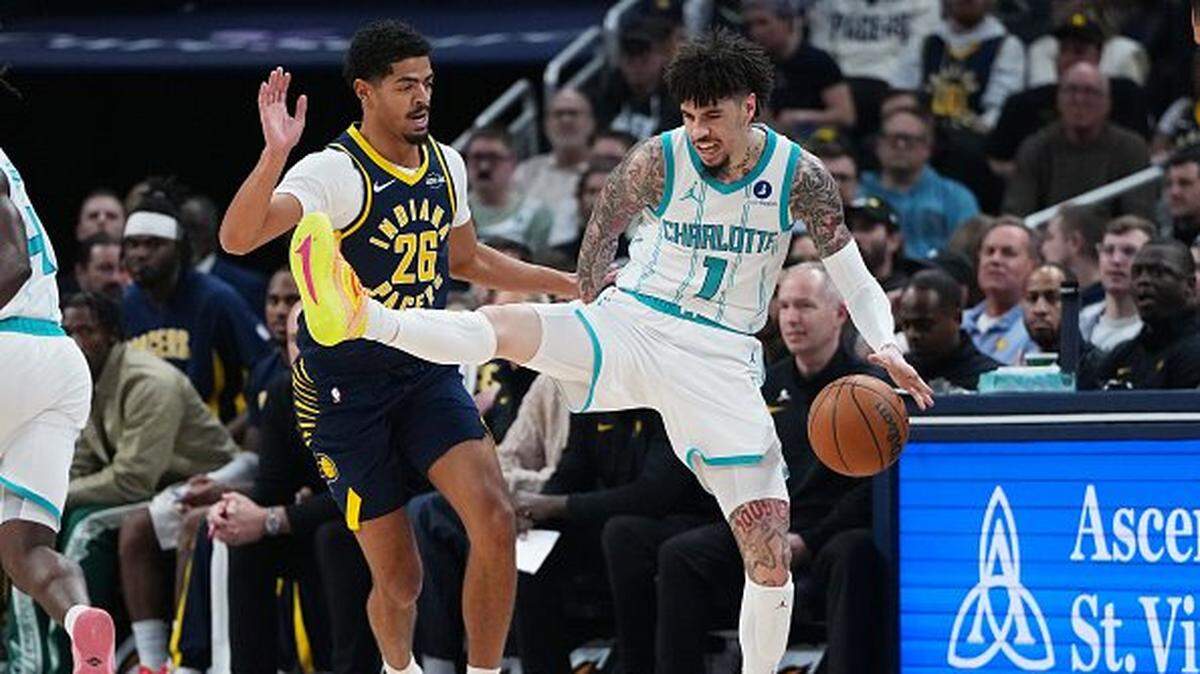 LaMelo Ball of the Charlotte Hornets dribbles the ball against Ben Sheppard of the Indiana Pacers in the first quarter at Gainbridge Fieldhouse on November 19, 2025 in Indianapolis, Indiana.