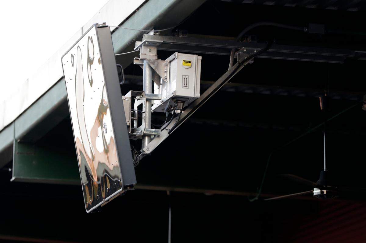 In this July 10, 2019 file photo, a radar device is seen on the roof behind home plate at PeoplesBank Park during the third inning of the Atlantic League All-Star minor league baseball game in York, Pennsylvania. The independent Atlantic League became the first American professional baseball league to let the computer call balls and strikes during the All-Star game. (AP Photo/Julio Cortez, File)
