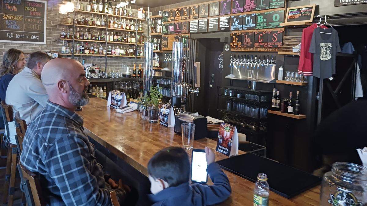 Bryan Rinehart and his son, Hudson, 4, hang out at the bar at Beer Lab by Ghostface Brewing.