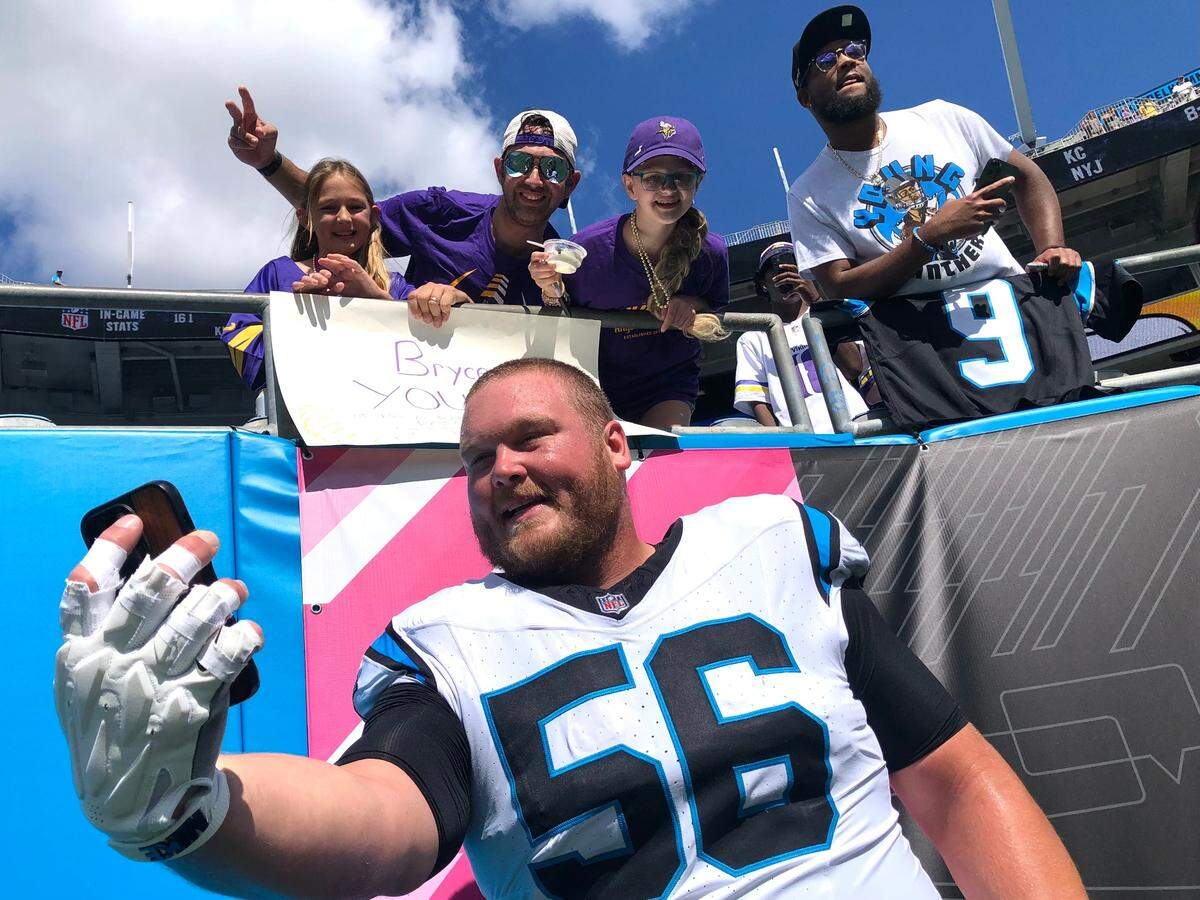 Carolina Panthers center Bradley Bozeman takes a selfie with fans prior to the team’s game against the Minnesota Vikings on Sunday, October 1, 2023 at Bank of America Stadium in Charlotte, NC.