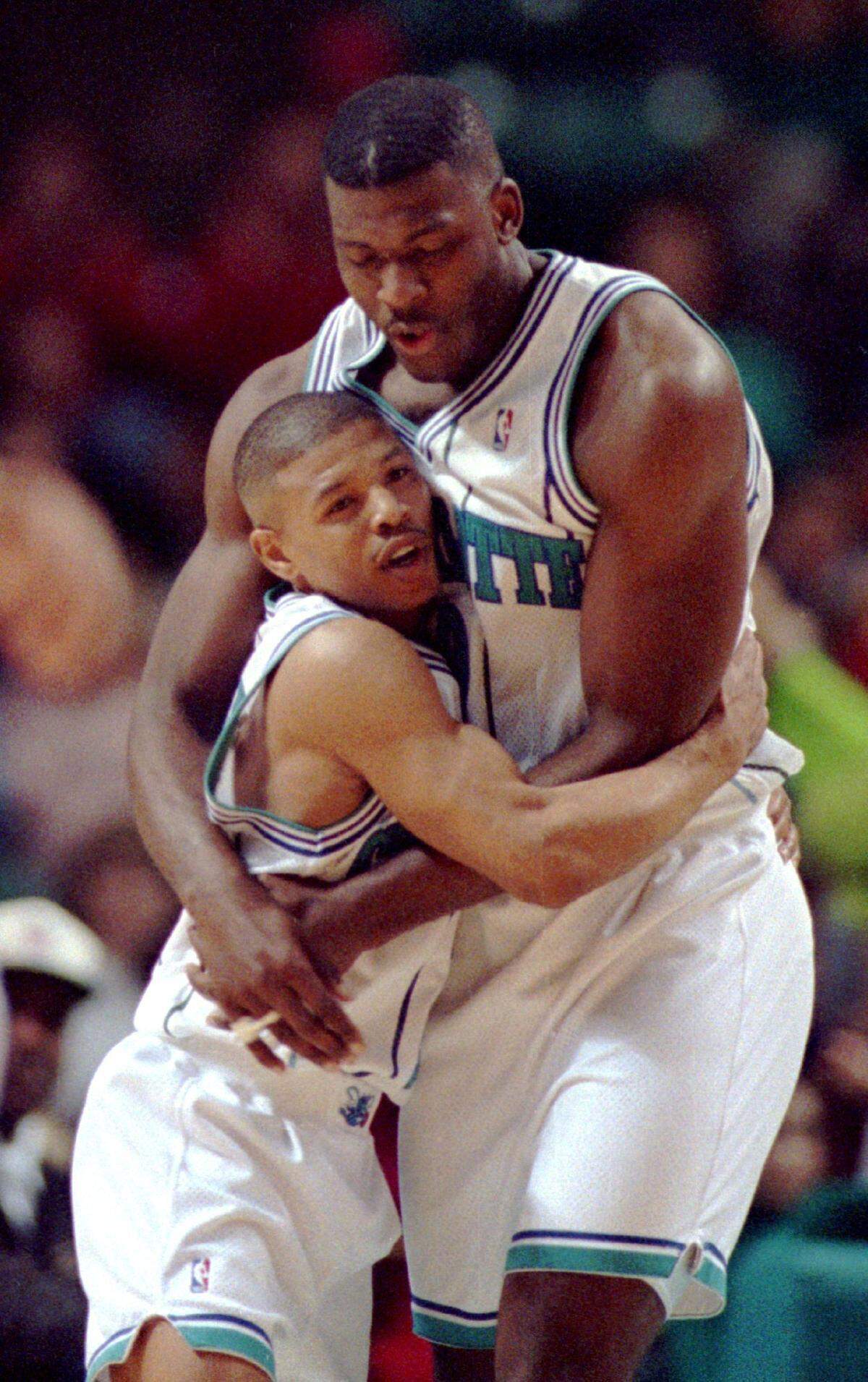 On Feb. 25, 1993, Muggsy Bogues, left, and Larry Johnson embrace during a Charlotte Hornets win over San Antonio. Bogues will join the team this year as a Hornets ambassador for the team's 30th anniversary.