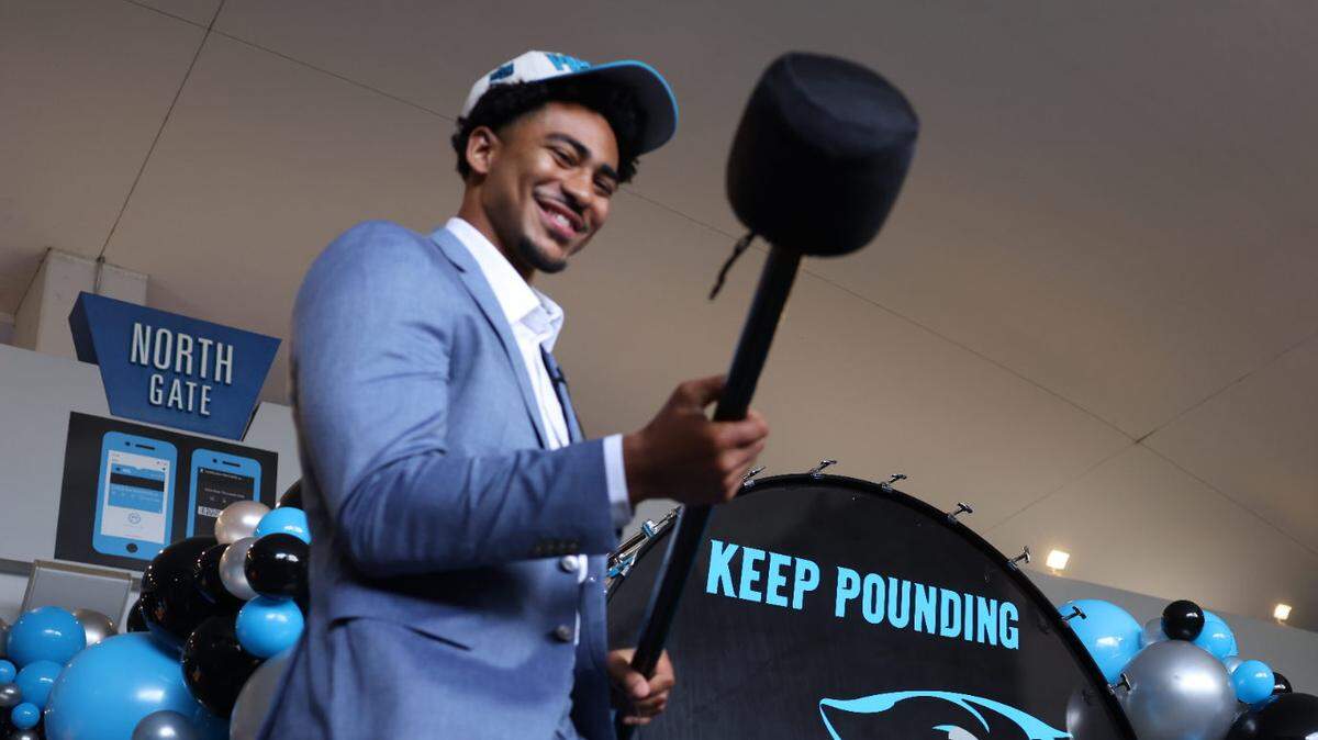 Carolina Panthers QB Bryce Young gets ready to pound the drum before making his way into the Bank of America Stadium Friday morning, April 28, 2023. Fans gather at the North Gate to welcome Young to Charlotte.