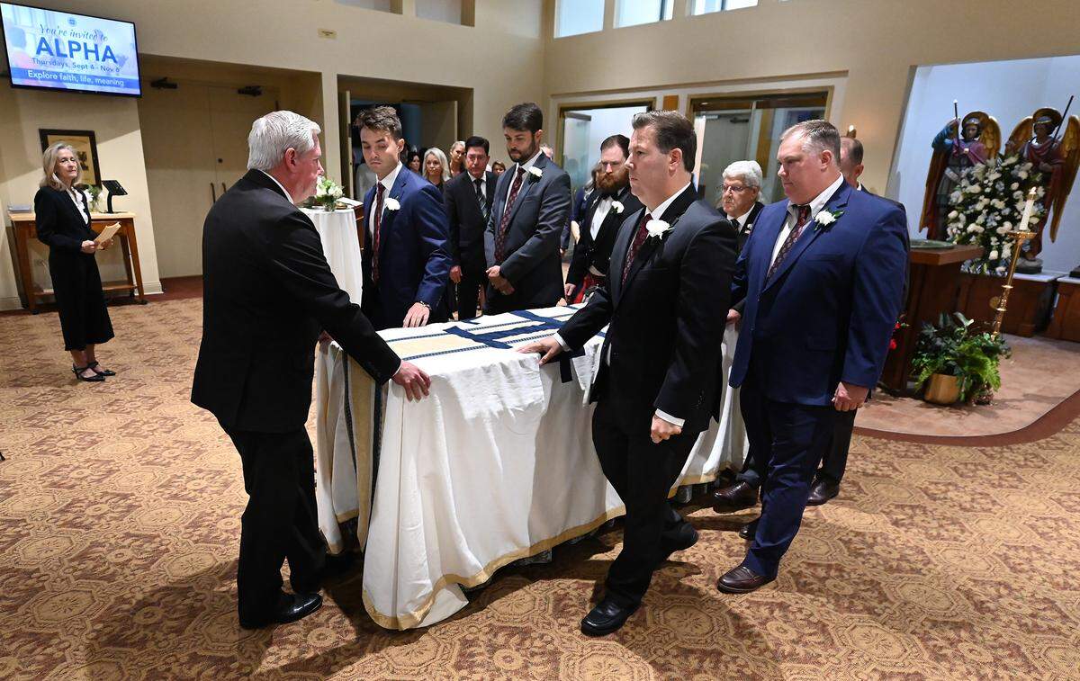 Pallbearers prepare for the funeral of former longtime Charlotte Motor Speedway president H.A. “Humpy” Wheeler, Jr.,on Tuesday, August 26, 2025 at St. Gabriel Catholic Church in Charlotte.