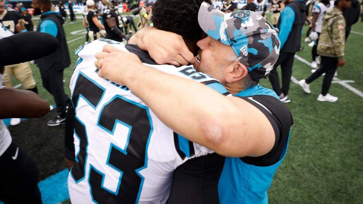 Carolina Panthers head coach Matt Rhule hugs Carolina Panthers defensive end Brian Burns (53) after the Panthers defeated the New Orleans Saints 22-14 during a game at Bank of America Stadium in Charlotte, N.C., Sunday, Sept. 25, 2022.
