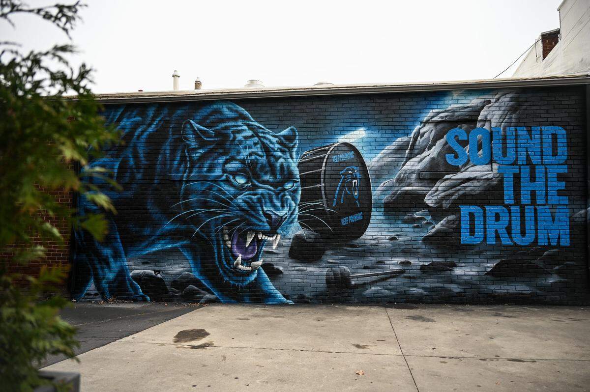 A new Panthers mural by Matt Moore, aka Puck McGruff, is finnished in time for tomorrow’s Wild Card playiff game between the Panthers and the Rams. The mural can be seen on Camden Road in South End.