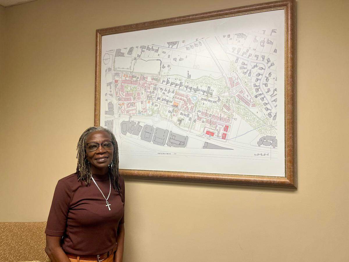 Lisa Mayhew-Jones, the interim executive director of the Smithville CommUNITY Coalition, stands in front of a grid of Smithville, an historically Black community in Cornelius.