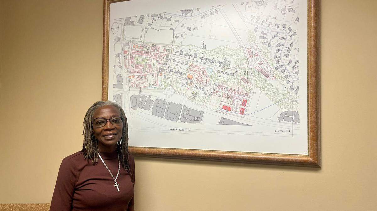 Lisa Mayhew-Jones, the interim executive director of the Smithville CommUNITY Coalition, stands in front of a grid of Smithville, an historically Black community in Cornelius.
