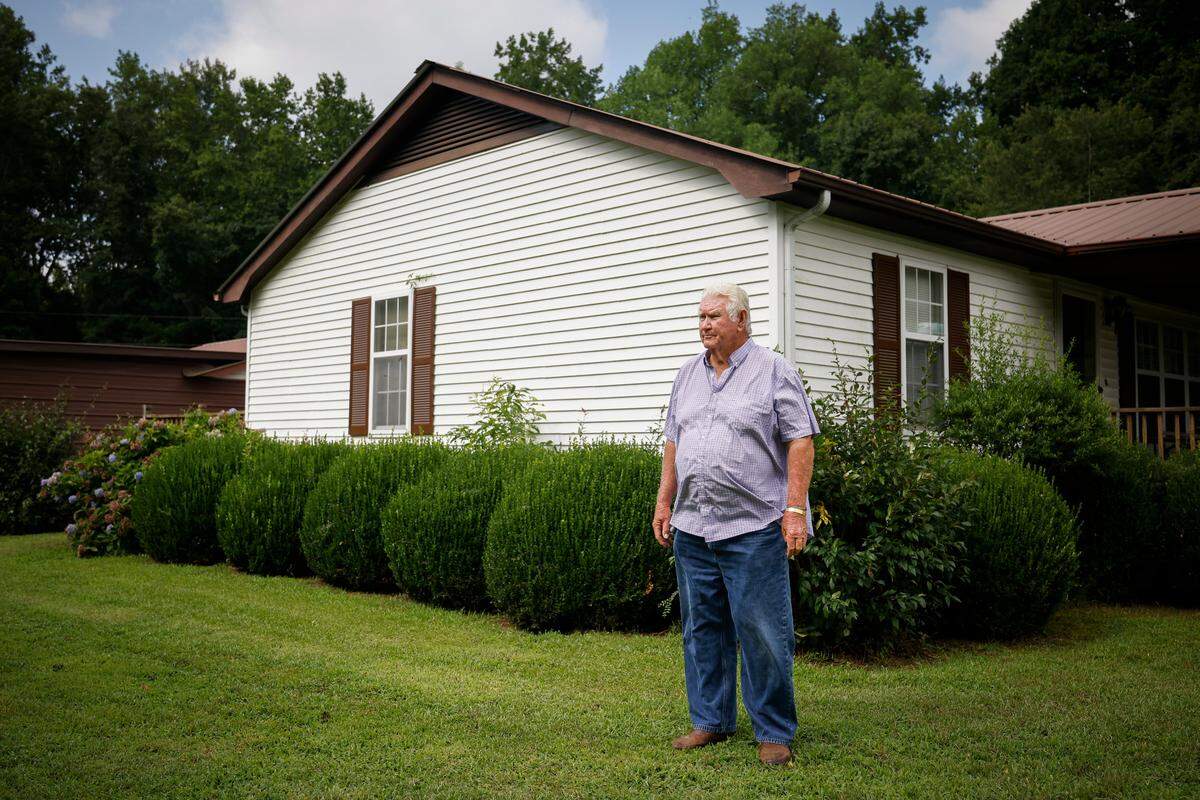 Johnny “Van” Garris, pictured outside his house in Anson County, says the many industrial-scale poultry farms that have cropped up near his home have brought strong odors and vultures, disrupting his family’s quality of life.