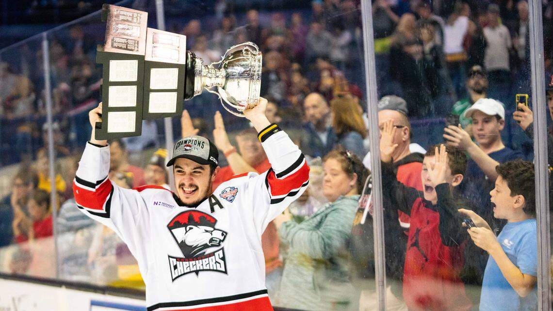 Charlotte Checkers forward Andrew Poturalski shows off the hardware to the fans at Allstate Arena after the team’s Calder Cup-clinching victory over Chicago Wolves in Game 5 of the series in Rosemont, Ill., on Saturday. It’s the first championship for the Checkers after nine seasons in the league. Poturalski was named the most valuable player for the AHL playoffs.