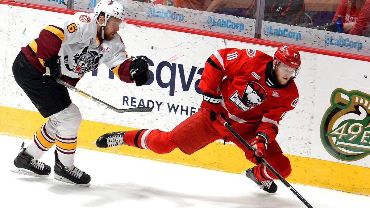 Charlotte Checkers center Steven Lorentz (10) battles the Chicago Wolves’ Griffin Reinhart during the 2019 AHL Calder Cup Finals at Bojangles’ Coliseum.