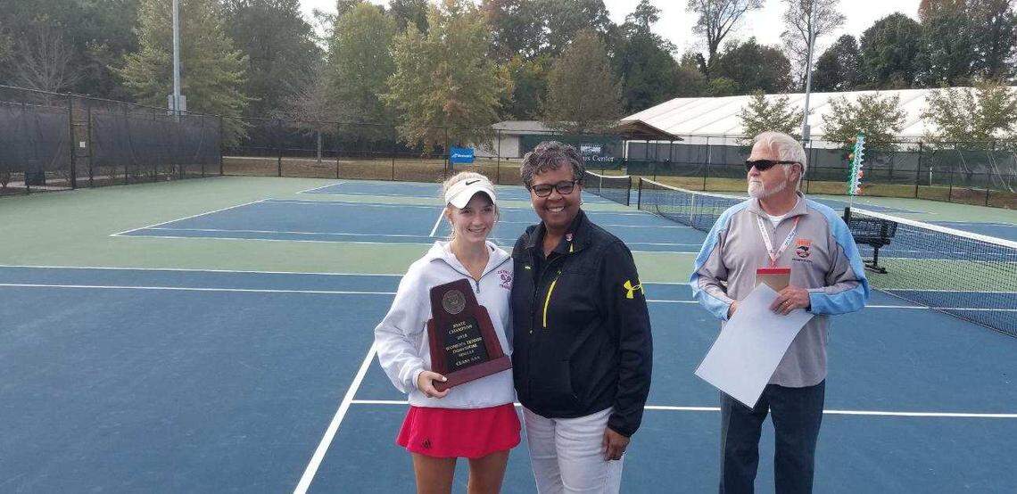 Charlotte Catholic’s Rose Kenny (left) with N.C. High School Athletic Association commissioner Que Tucker, after winning the N.C. 3A state championship tennis title Saturday.