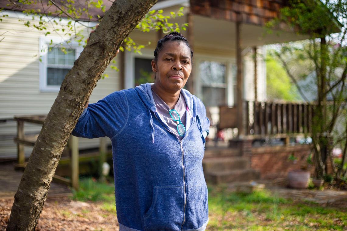 Jeanette McClure stands for a portrait outside her home in West Charlotte, NC on Friday, March 20, 2020. McClure saw her hours go down last week then was furloughed indefinitely from her job as a cook at the Charlotte Douglas International Airport. “It’s really quite unnerving to think about where we’re going to be at next month, because we will have to pay rent again,” McClure said adding that her job only provided her family to live paycheck to paycheck.