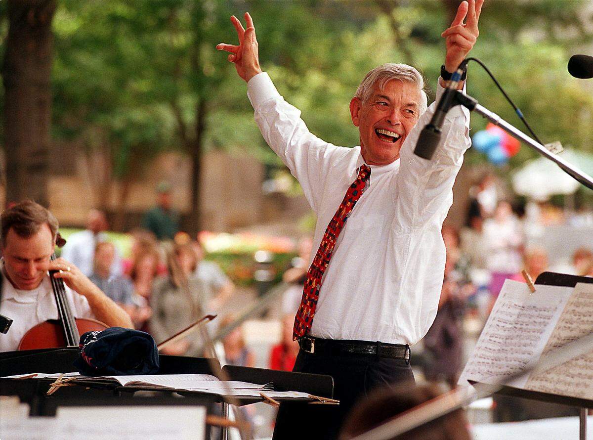 Hugh McColl leads the Charlotte Symphony Orchestra in this 1998 file photo. At the time, McColl was given an award by the International Downtown Association for his contributions to the arts.