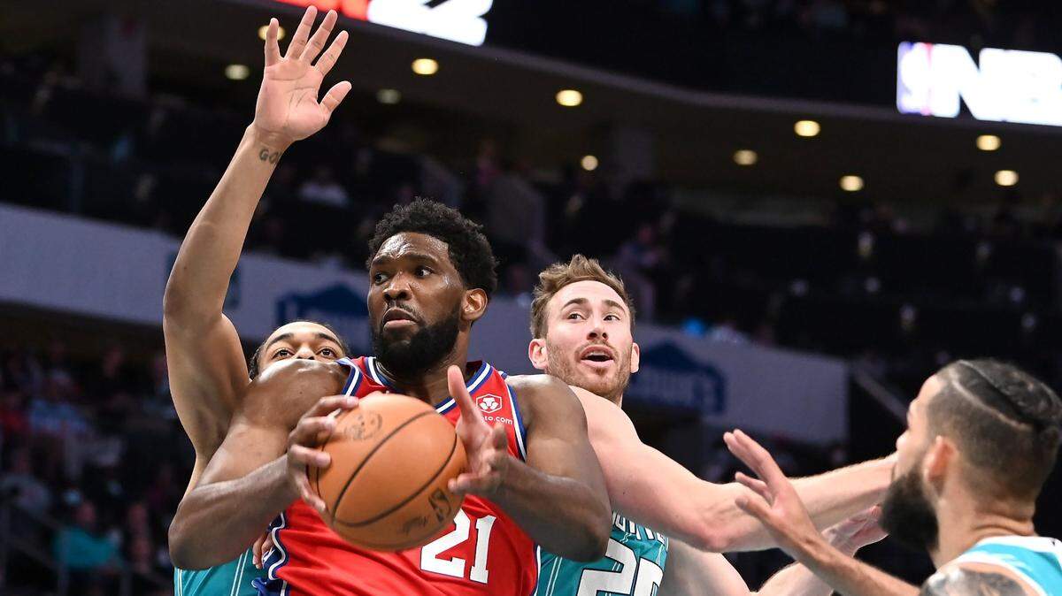 Philadelphia 76ers center Joel Embiid (21) fights his way to the basket as Charlotte Hornets forwards PJ Washington, left, Gordon Hayward, back center, and Cody Martin try to stop him. The Hornets have long been without a quality starting center to defend the post and it’s what NBA insiders say they need to take the next step.