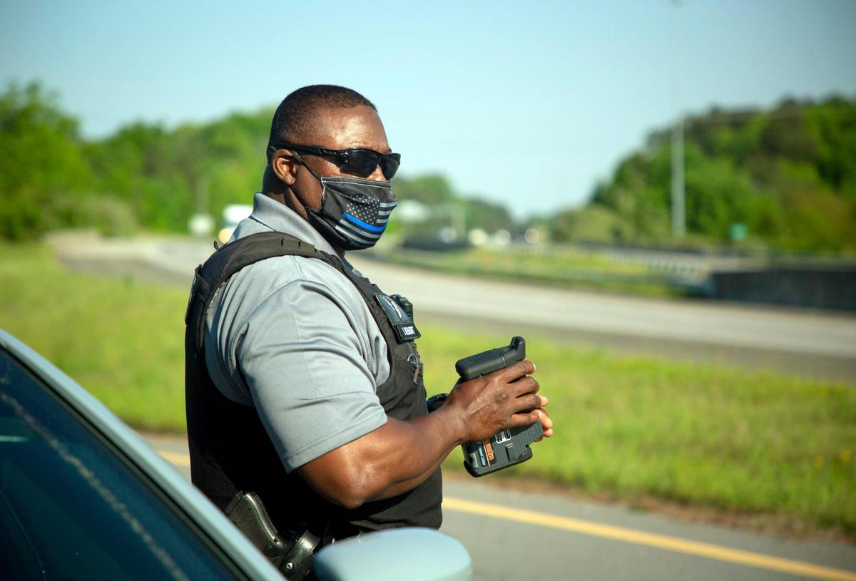 Using LiDAR, a speed-detection technology that uses lasers, Durham County Sheriff’s Deputy V. Stewart monitors the speed of cars traveling on I-85 recently.