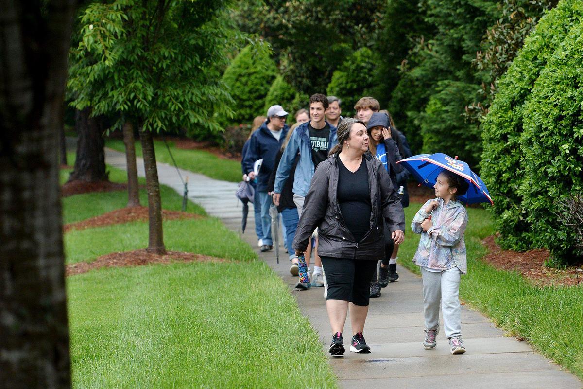 Robyn Medlin and her seven-year-old daughter, McKinley Medlin, are among the parents and students from the Olde Providence subdivision who walked to Providence High School to demonstrate just how close the school is to their neighborhood. Currently, students at the Olde Providence community go to Myers Park High, but the redrawing will send them to South Mecklenburg High School