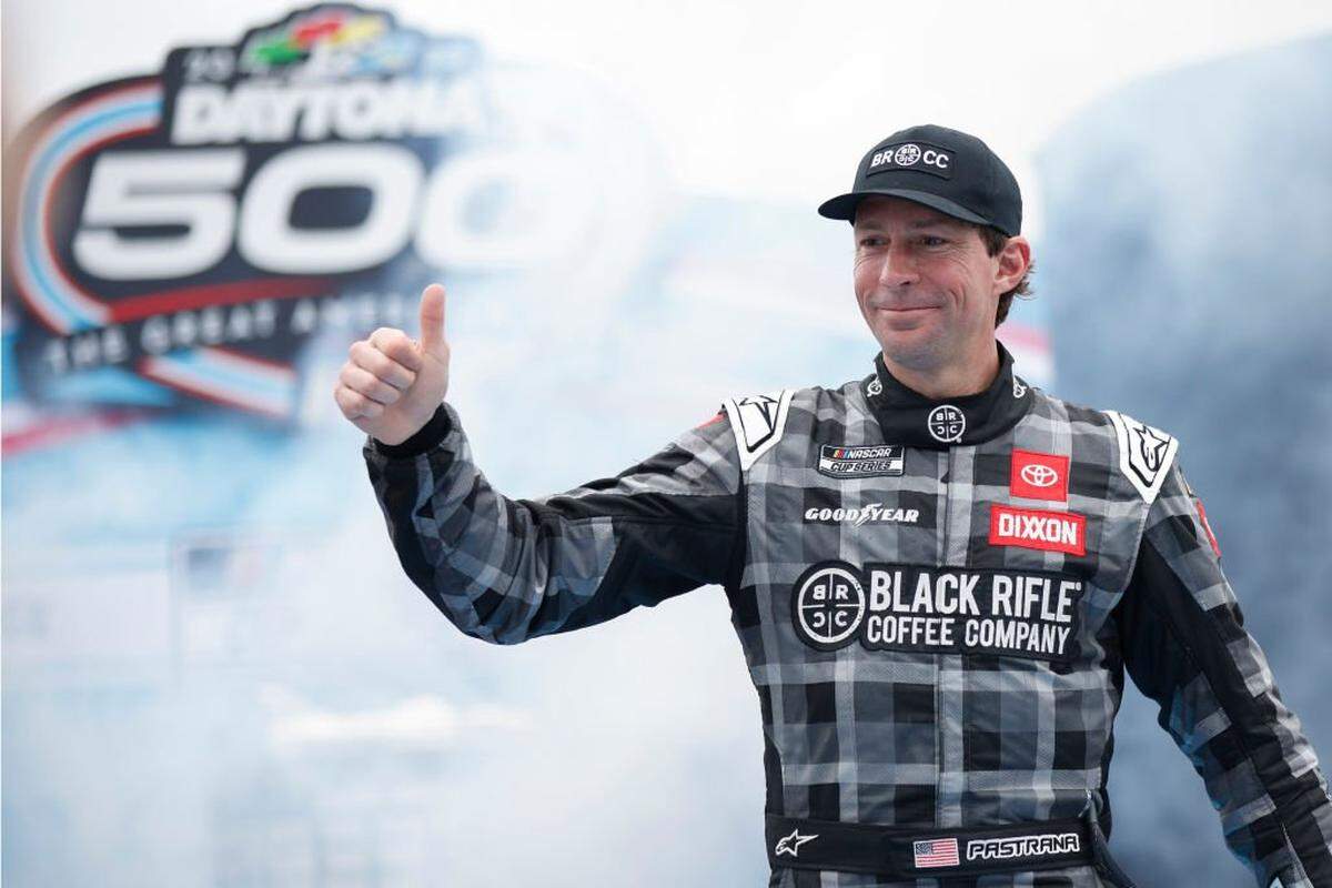 Travis Pastrana, driver of the #67 Black Rifle Coffee Toyota, gives a thumbs up to fans as he walks onstage during driver intros prior to the NASCAR Cup Series 65th Annual Daytona 500 at Daytona International Speedway on Feb. 19, 2023 in Daytona Beach, Florida.