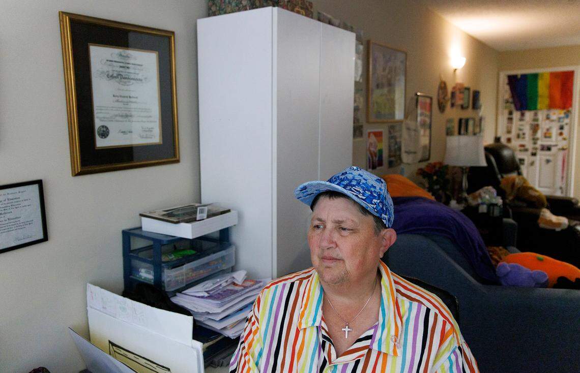 Kerry Holbrook sits near a cabinet in her Durham apartment where she keeps dozens of medical bills. Now she hopes North Carolina’s new debt forgiveness program will offer some relief.