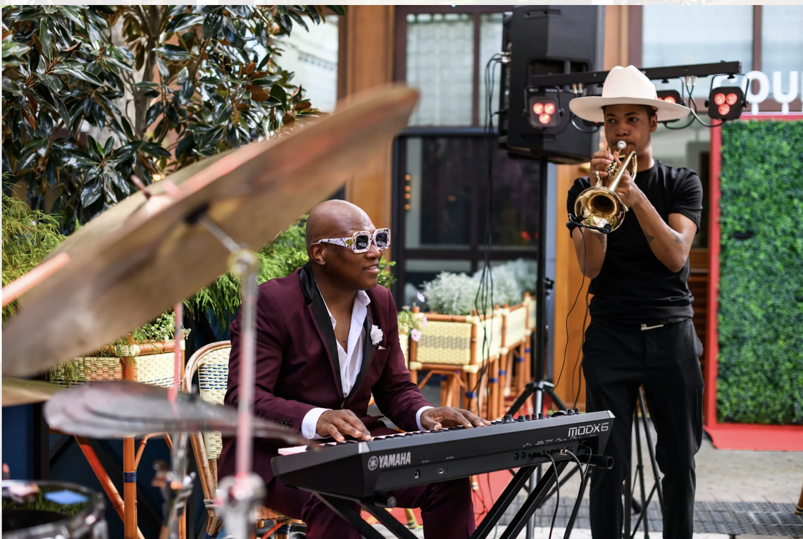 Harvey Cummings II, left, and Braxton Bateman on trumpet, in an outdoors performance around Charlotte.