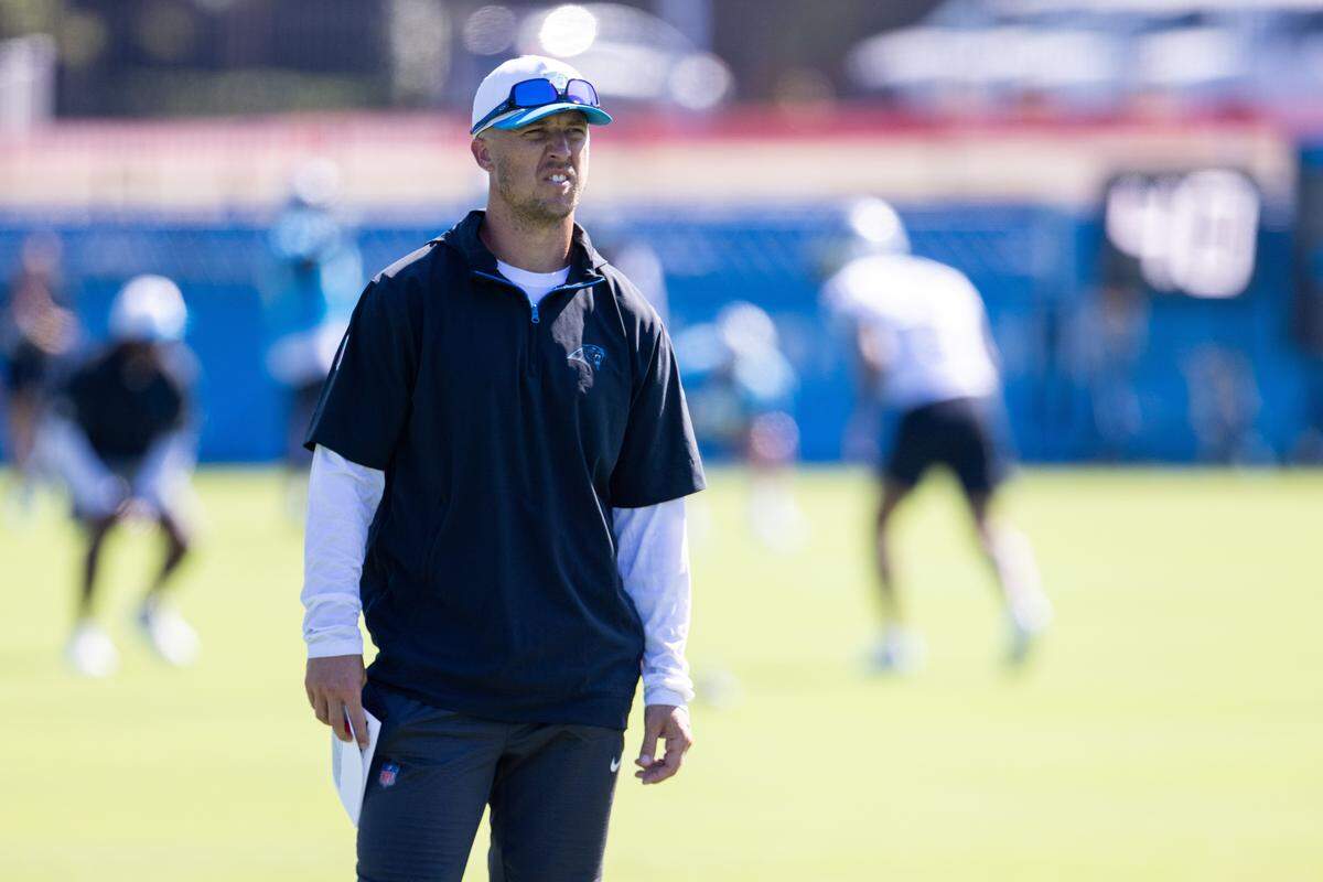 Carolina Panthers offensive coordinator Brad Idzyk watches practice during training camp on July 26, 2025.