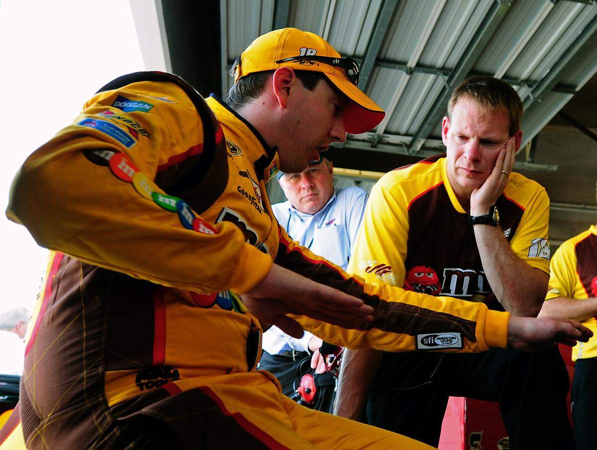 (L-R) NASCAR Sprint Cup Series driver Kyle Busch talks with his crew chief Dave Rogers following practice on Friday, February 24, 2012 at Daytona International Speedway. Jeff Siner - jsiner@charlotteobserver.com 