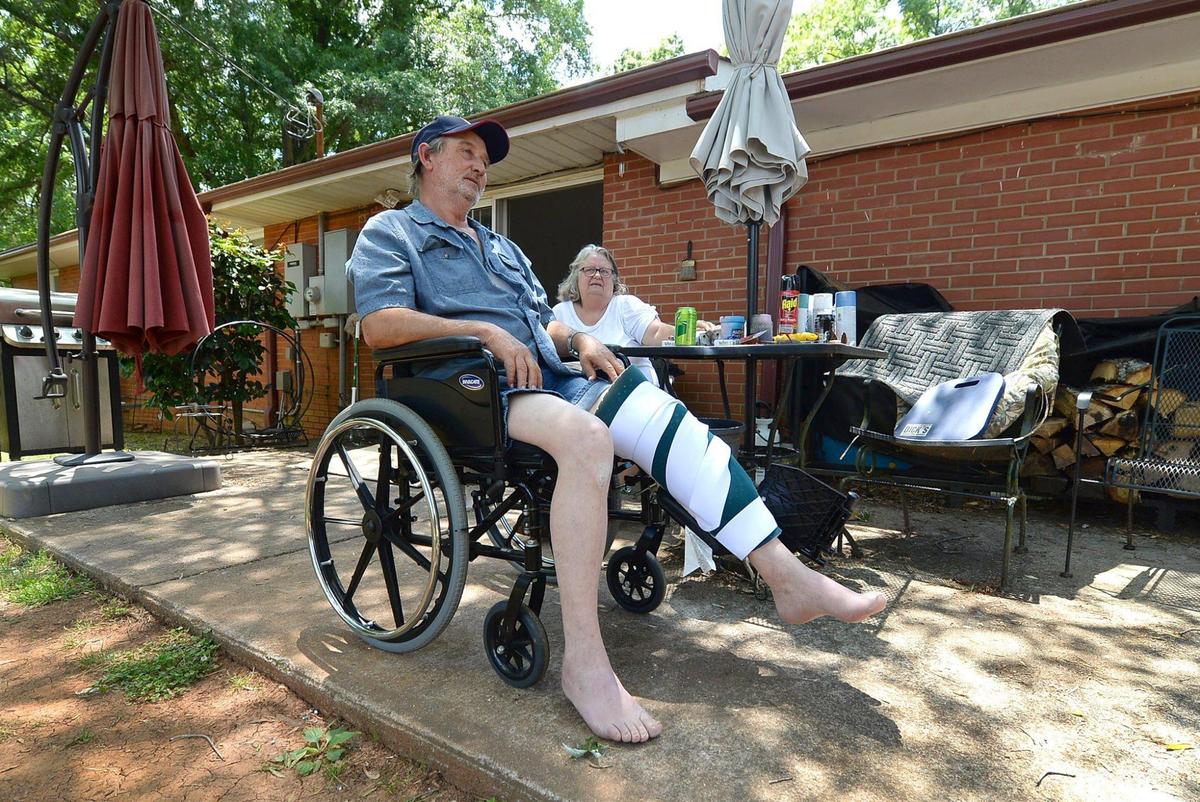 Lee Martin, left and his wife, Tammy, sit on the patio of their home in Mint Hill, NC on Wednesday, May 19, 2021. Martin says two Amazon drivers attacked and seriously injured him as he spoke up for a neighbor in his 80s who had told them to slow down on their private gravel road. Martin says that he was treated at a hospital for a head wound and bruises all over his body after the drivers knocked him to the ground and beat him.