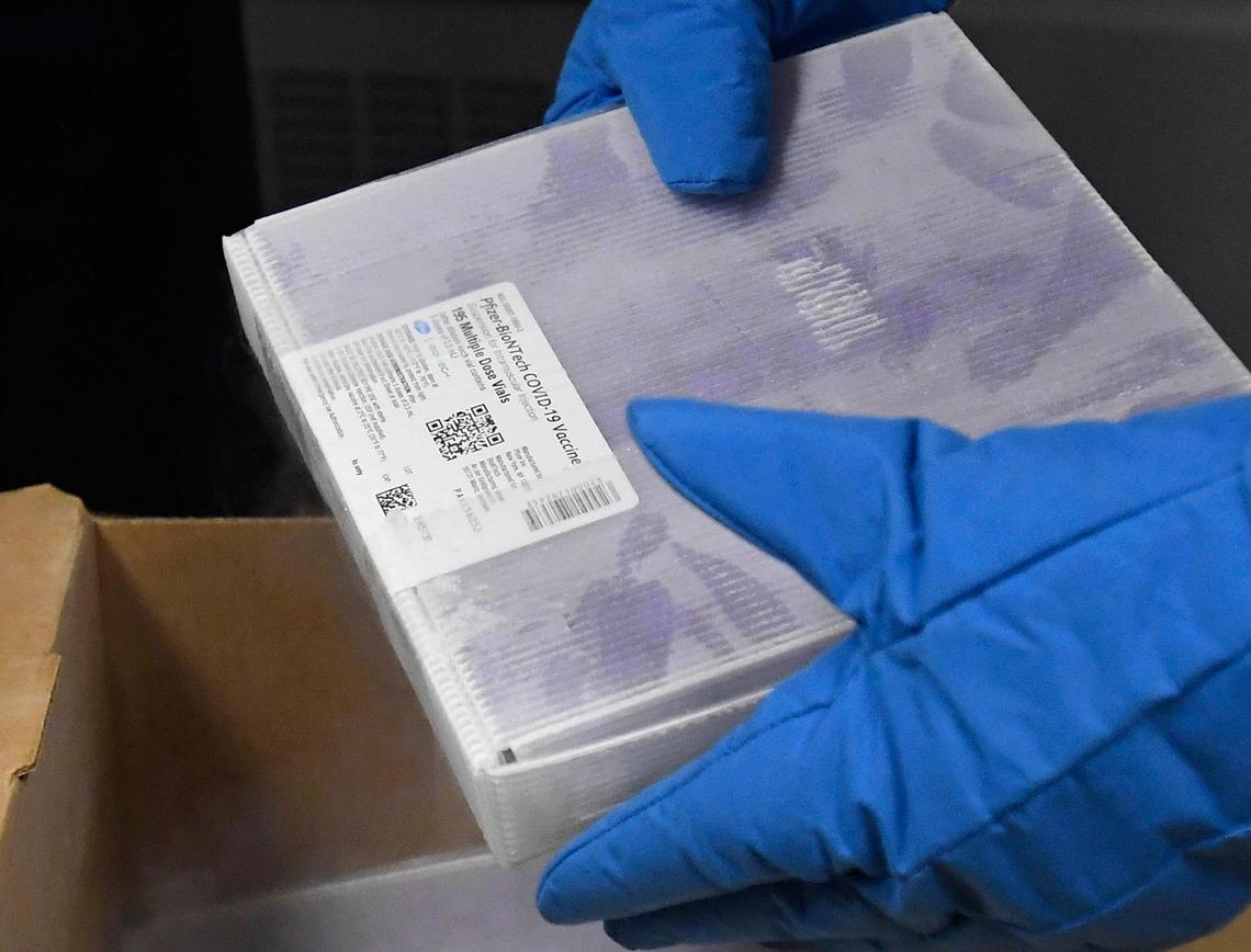 Novant Health’s Brad Petersen, Pharmacy Operations Manager, unpacks a container of COVID vaccine at Novant Health Presbyterian Medical Center after it was delivered on Thursday, December 17, 2020.