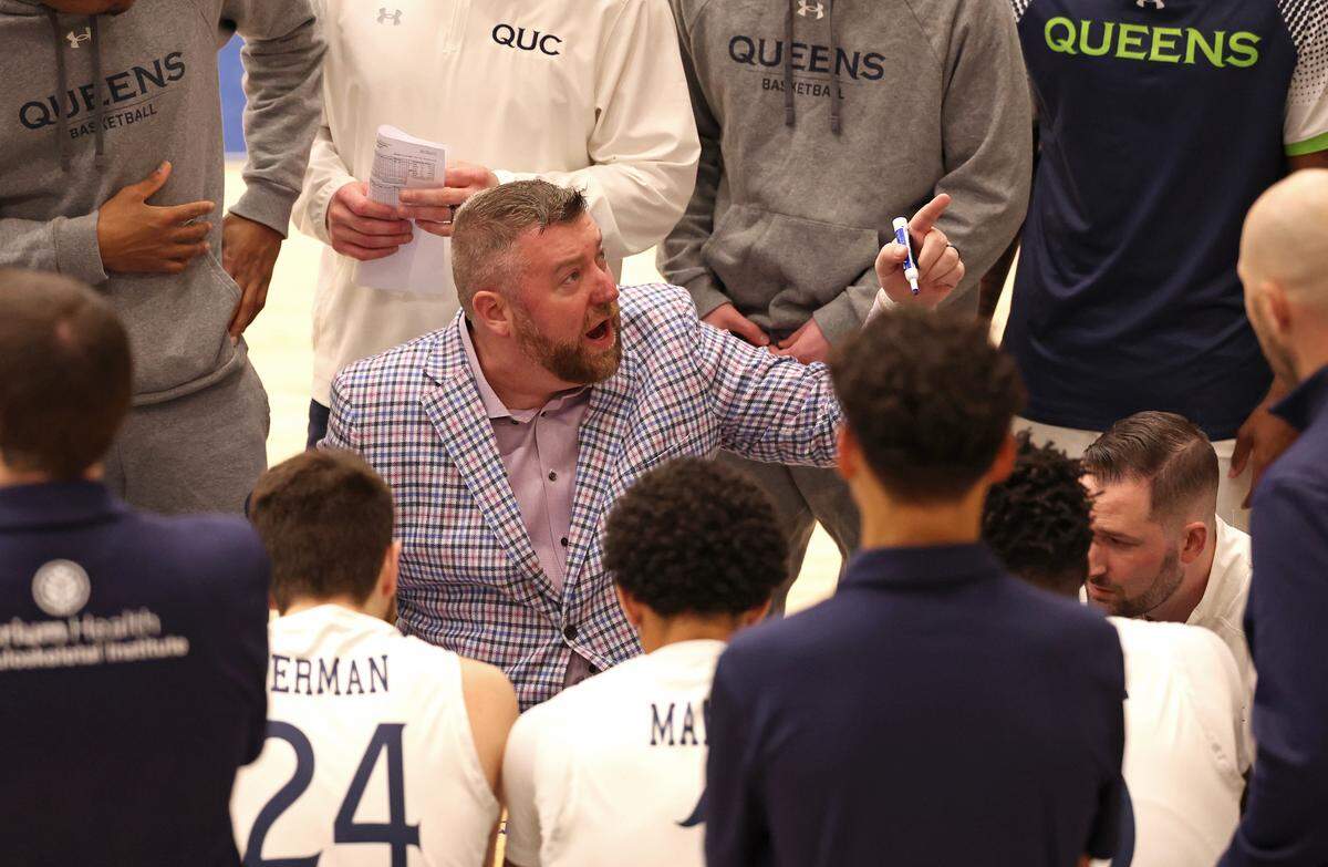 Queens University head coach Grant Leonard, center, speaks to his team during a January, 2025, game at Curry Arena.