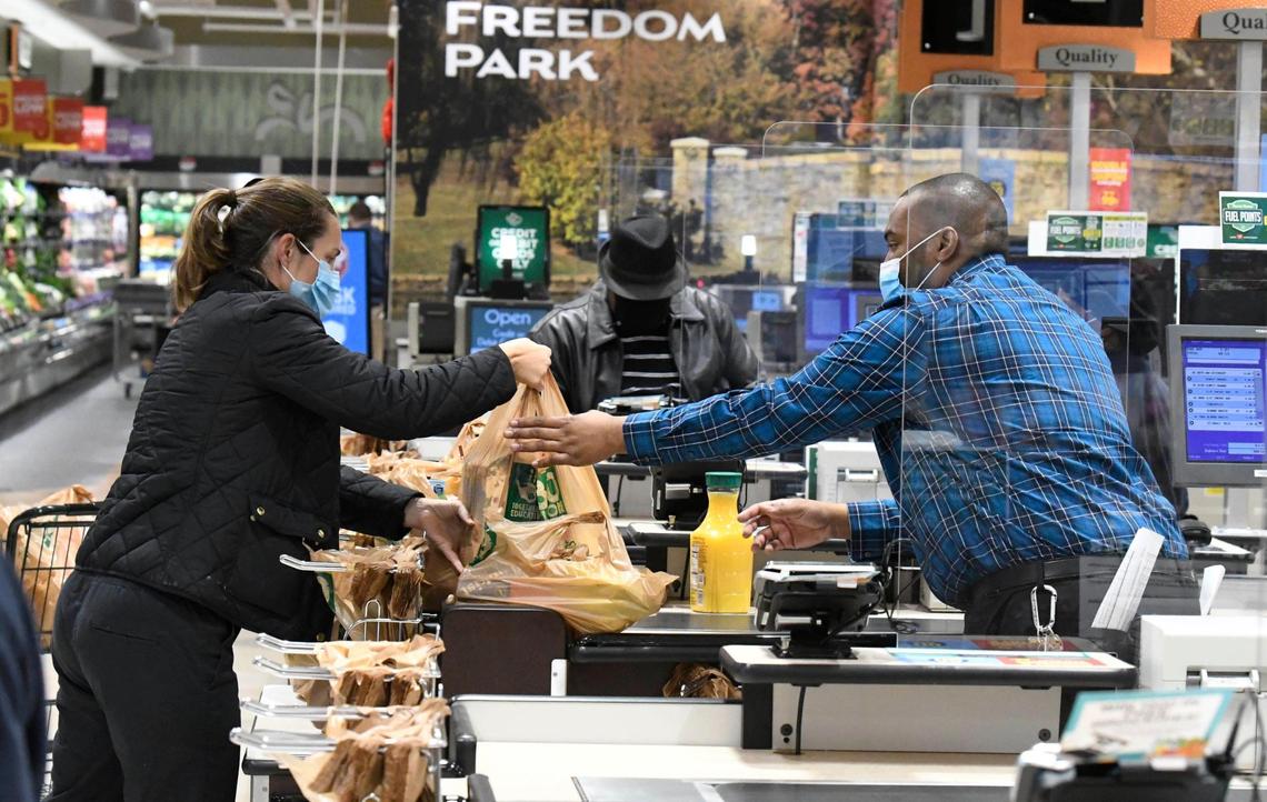 Original: Customers checkout at the newly reopened Harris Teeter in the Park Road Shopping Center on Wednesday, January 13, 2021. The store originally opened in 1984 and served the Park Road the for nearly 36 years before temporarily closing for remodeling in January 2020. The 34,000 square foot store has 6 checkouts and 8 express checkouts and features include store made pizzas, a beer and wine bar, and fresh sushi.