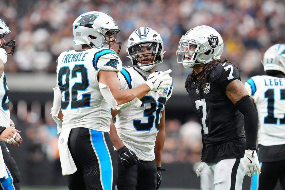 Sep 22, 2024; Paradise, Nevada, USA; Las Vegas Raiders safety Tre'von Moehrig (7) has words with Carolina Panthers tight end Tommy Tremble (82) and Las Vegas Raiders cornerback Darnay Holmes (30) during the fourth quarter at Allegiant Stadium. Mandatory Credit: Stephen R. Sylvanie-Imagn Images