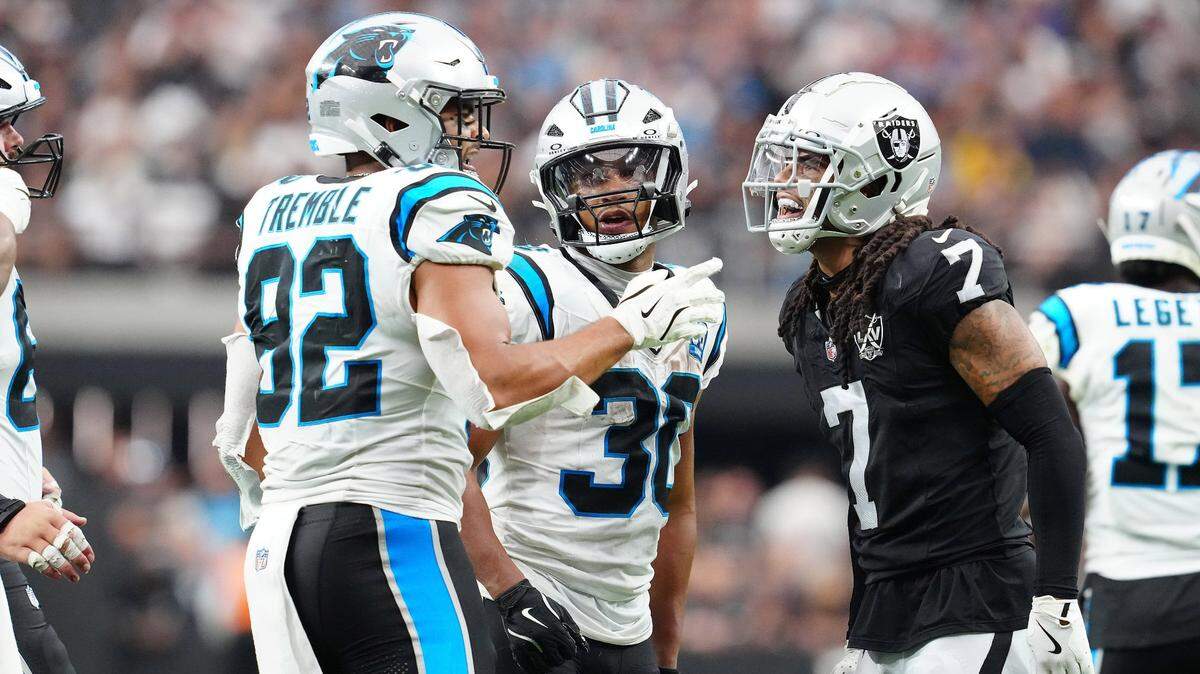 Sep 22, 2024; Paradise, Nevada, USA; Las Vegas Raiders safety Tre'von Moehrig (7) has words with Carolina Panthers tight end Tommy Tremble (82) and Las Vegas Raiders cornerback Darnay Holmes (30) during the fourth quarter at Allegiant Stadium. Mandatory Credit: Stephen R. Sylvanie-Imagn Images