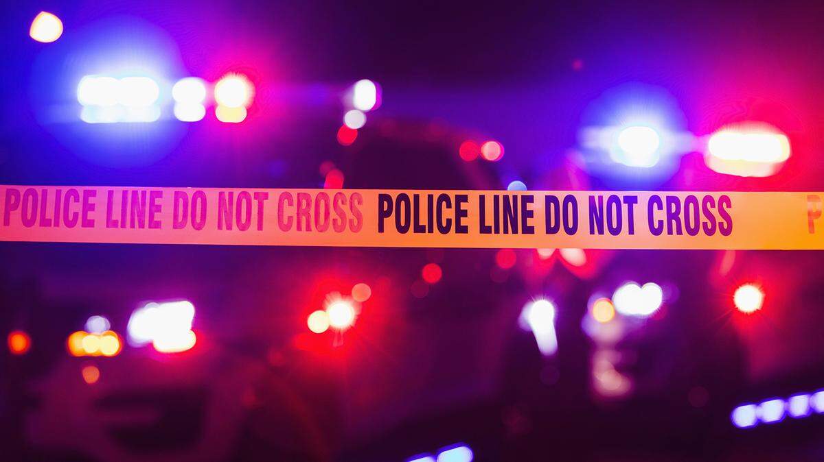 Accident or crime scene cordon tape, police line do not cross. It is nighttime, emergency lights of police cars flashing blue, red and white in the background Photo by Getty Images This is a stock image downloaded from Getty Images. It is a Royalty Free image. Getty Images | Royalty Free