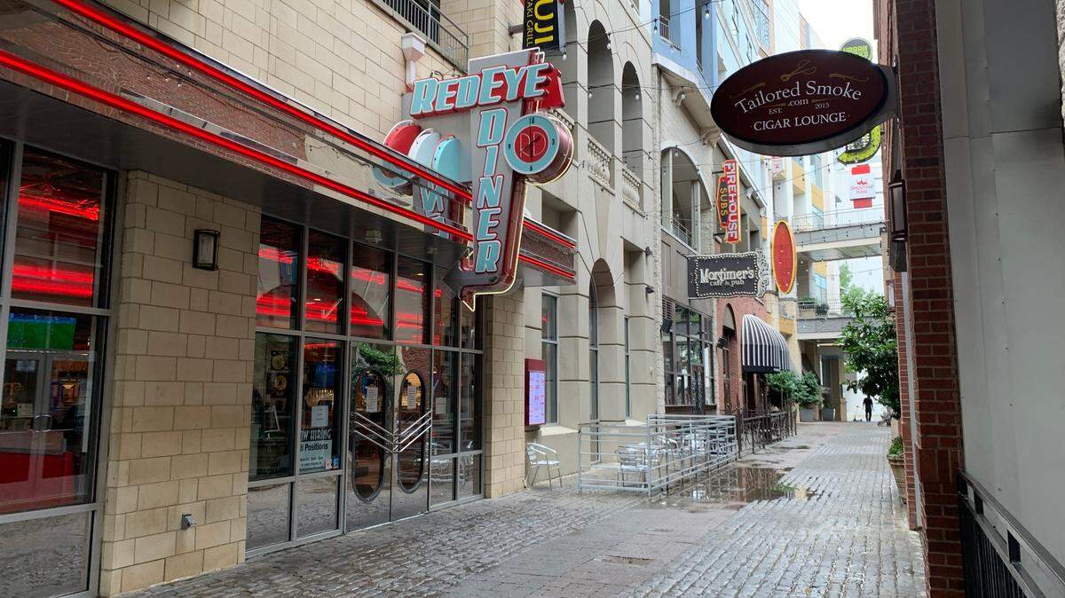 The bright red neon lights of Redeye Diner stand out in the Epicentre shopping center on July 2, in Charlotte.