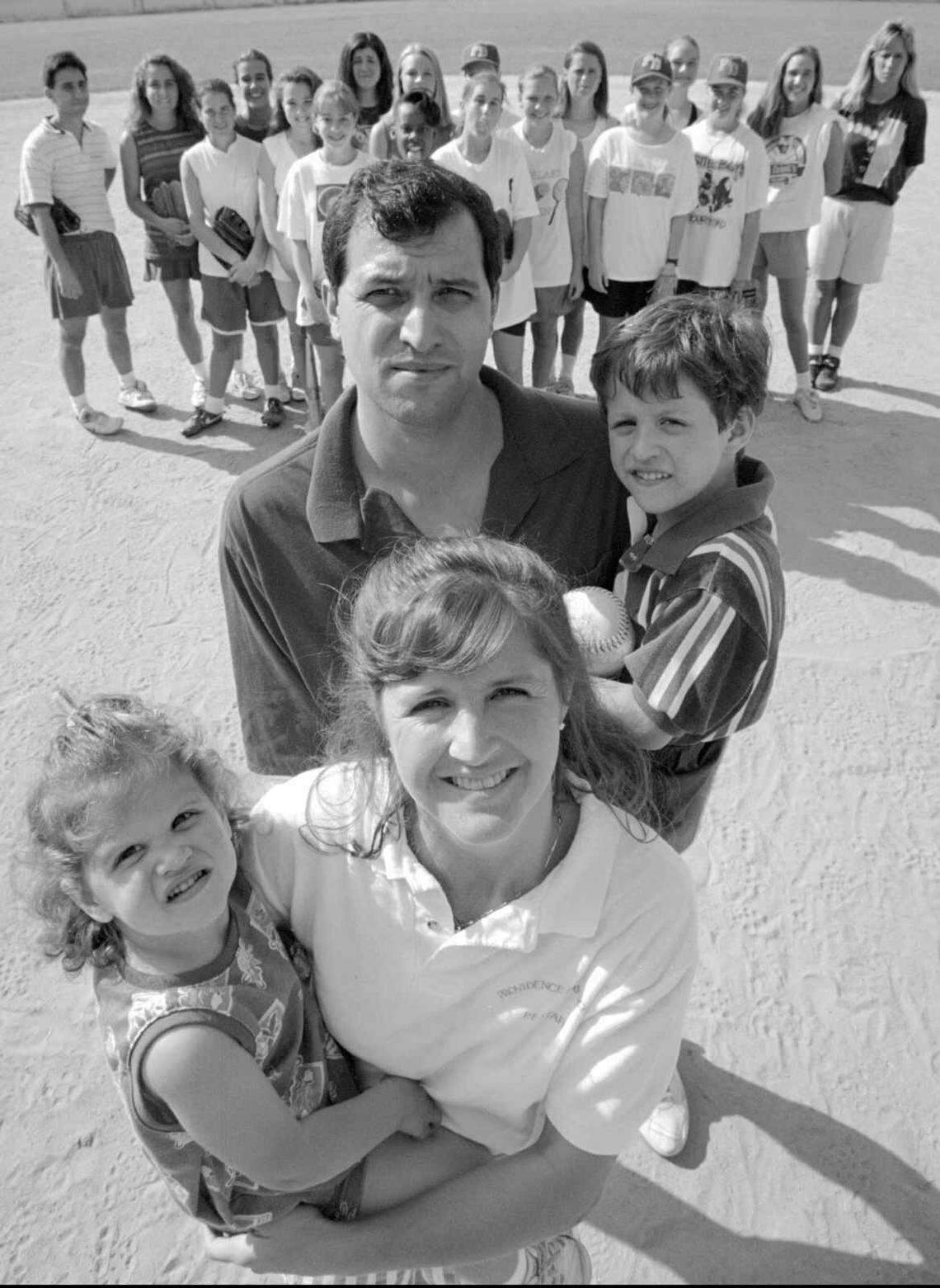 5/03/94 6B BOB LEVERONE/Staff JUGGLING ACT: Providence Day softball coach Barbara Nelson and husband Vernon have their hands full with daughter Haley, 2, and son Quinn, 5. The Chargers (background) are her second family.