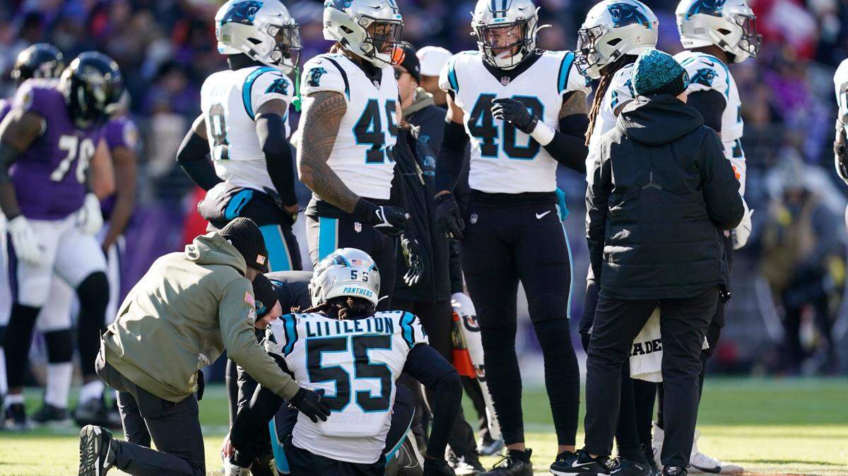 Carolina Panthers linebacker Cory Littleton (55) is helped by trainers in the first half of an NFL football game against the Baltimore Ravens Sunday, Nov. 20, 2022, in Baltimore. (AP Photo/Patrick Semansky)