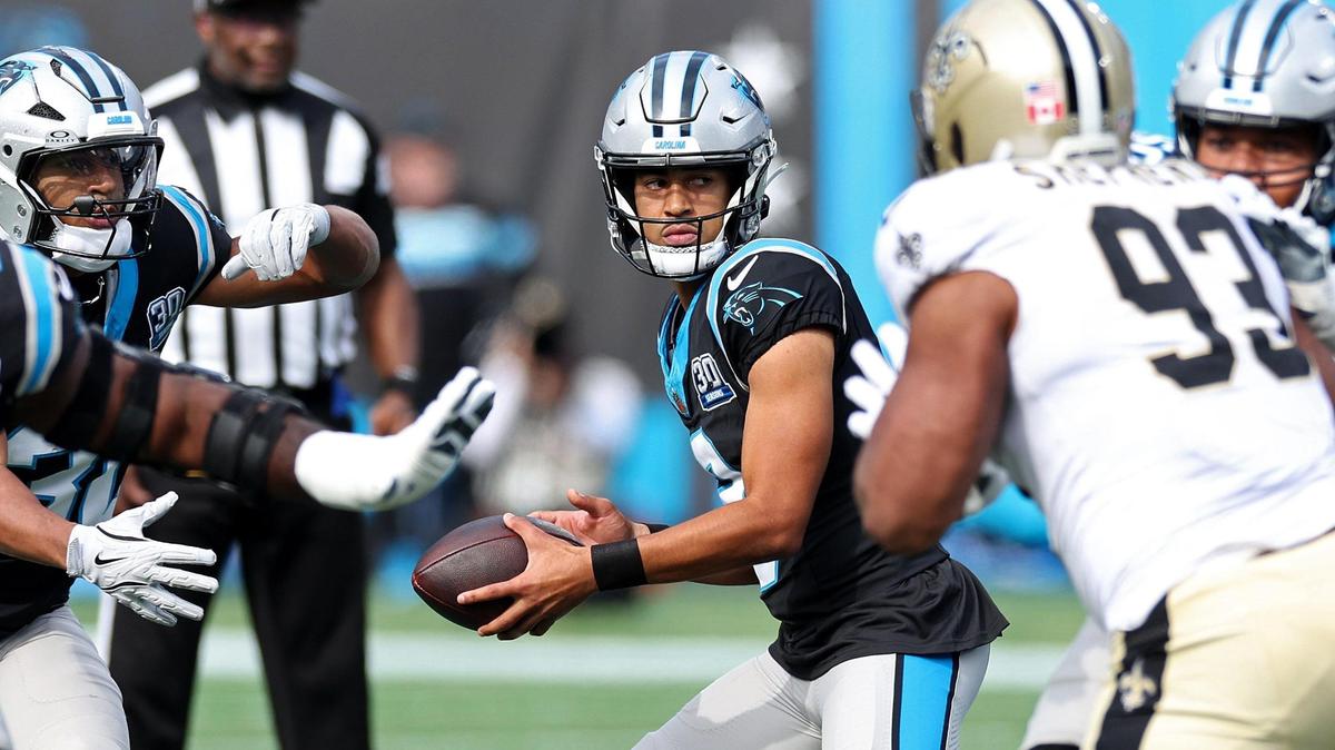 Carolina Panthers quarterback Bryce Young, center, drops back to hand the ball off as the New Orleans Saints defense rushes during action at Bank of America Stadium in Charlotte, NC on Sunday, November 3, 2024. The Panthers defeated the Saints 23-22