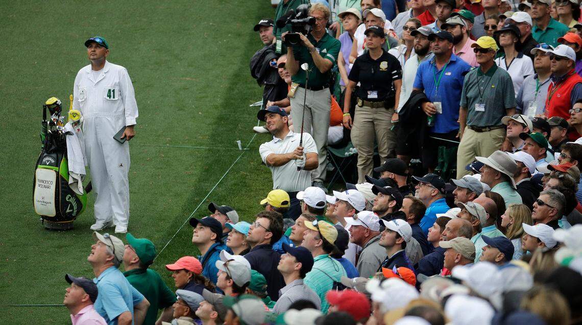 Final-round leader Francesco Molinari, hits the shot that cost him the Masters, a short pitch that found first a tree limb and then water on the 15th hole Sunday. (AP Photo/Charlie Riedel)