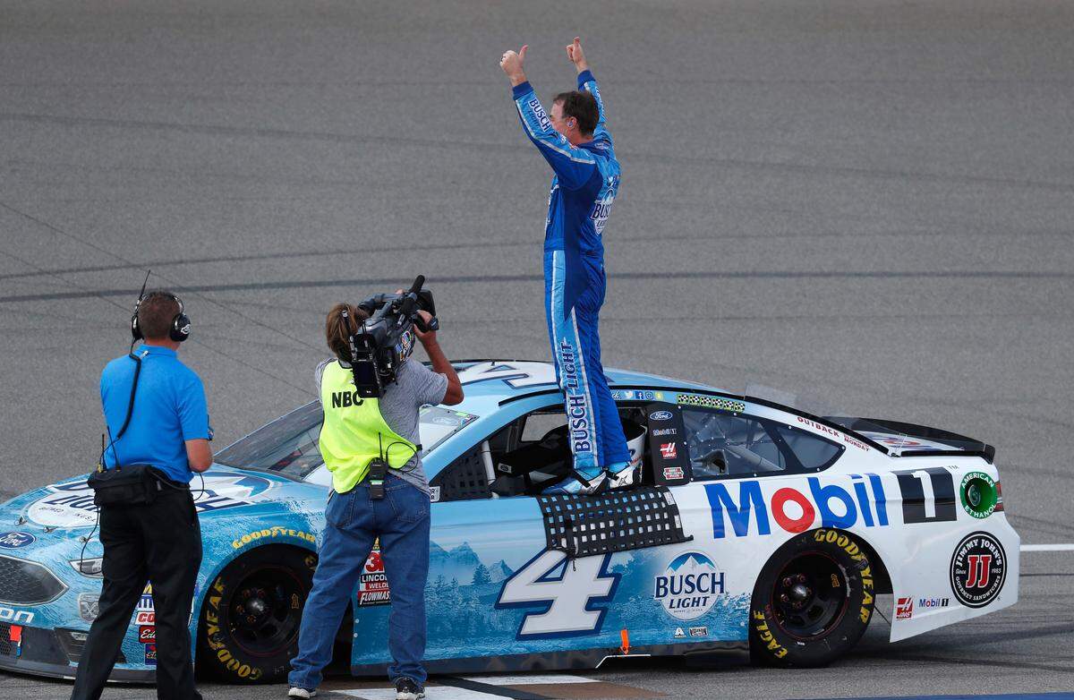 Kevin Harvick celebrates his victory after a NASCAR Cup Series auto race at Michigan International Speedway in Brooklyn, Mich., Sunday, Aug. 12, 2018. (AP Photo/Paul Sancya)