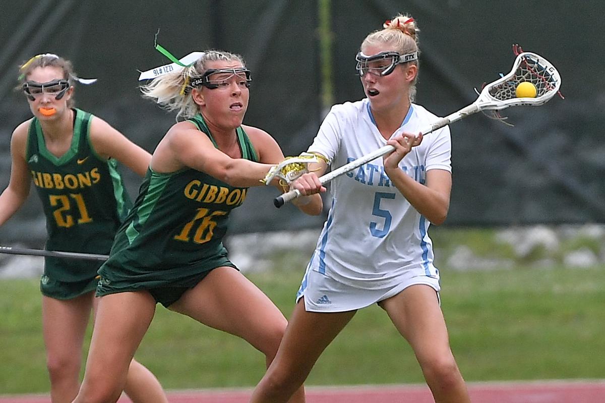 CHarlotte Catholic’s Mary Catherine Farley (5) looks to pass against Cardinall Gibbons’ Izzi Hammond (16) in the first half. Cardinal Gibbons and Charlotte Catholic met in the NCHSAA 4A Girls Lacrosse Final at Durham County Stadium on May 17, 2024.