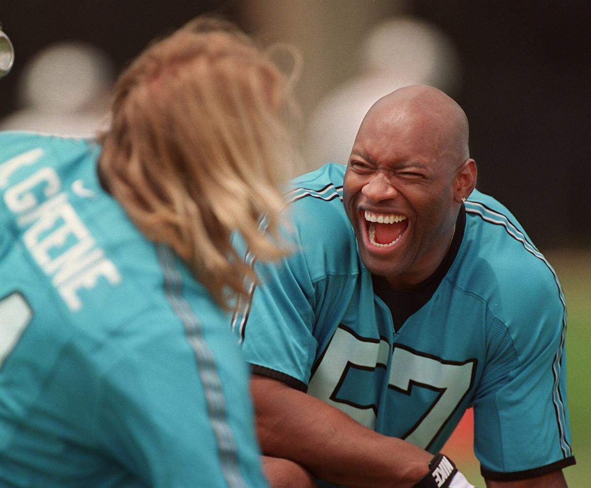 6/8/98 Carolina Panther linebacker (57) Lamar Lathon enjoys a laugh with teammate (91) Kevin Greene Monday afternoon during the team’s opening day of camp.
