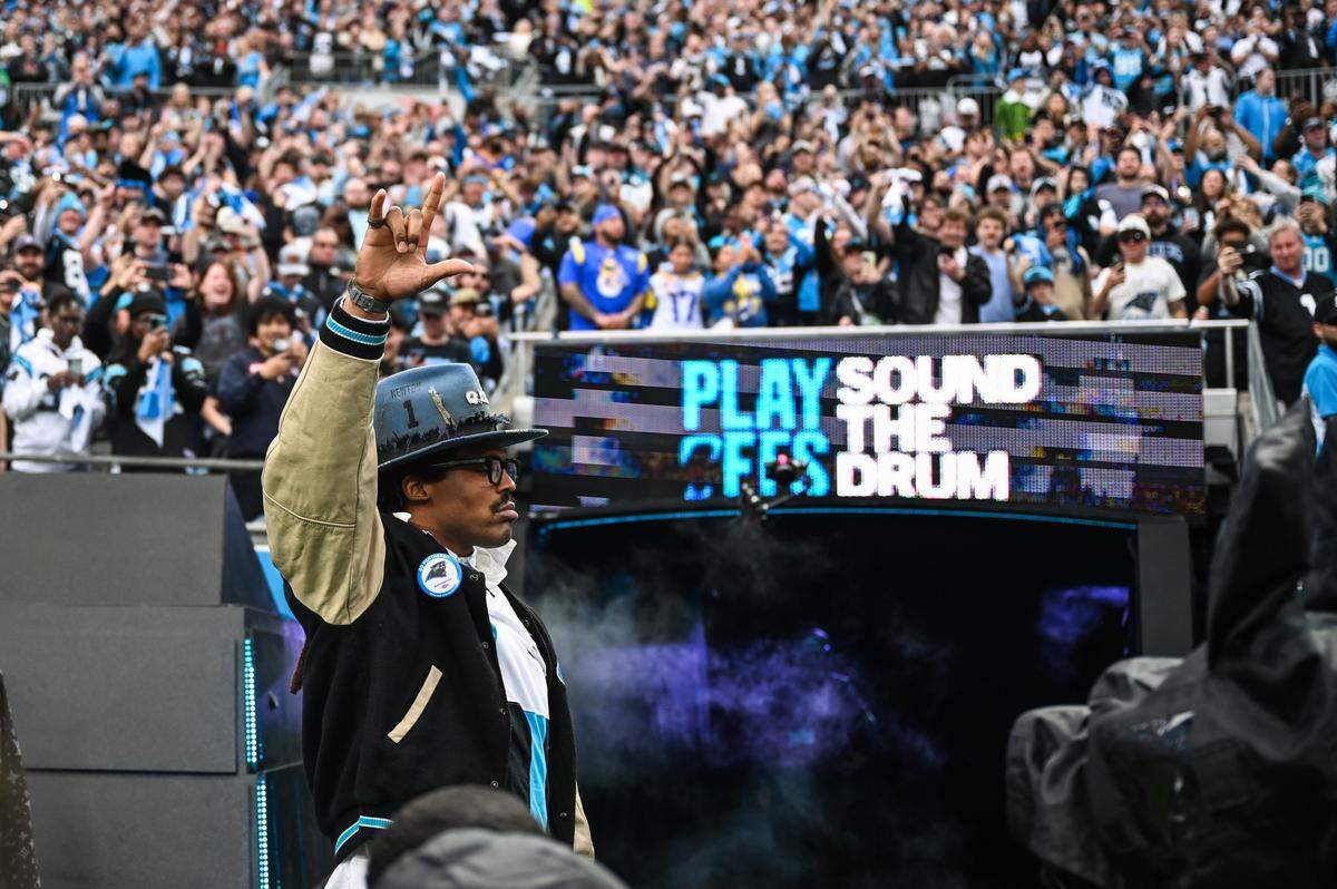 Cam Newton gestures to the crowd while on the field Saturday at Bank of America Stadium.